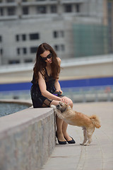 Image showing happy young woman with puppy have fun