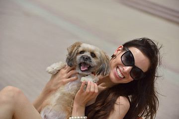 Image showing happy young woman with puppy have fun