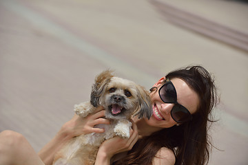 Image showing happy young woman with puppy have fun