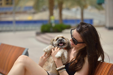 Image showing happy young woman with puppy have fun