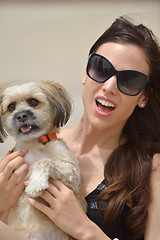 Image showing happy young woman with puppy have fun