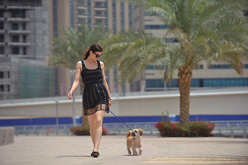 Image showing happy young woman with puppy have fun