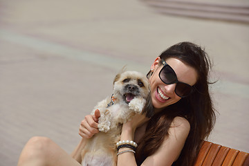 Image showing happy young woman with puppy have fun