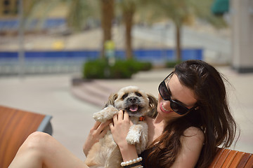 Image showing happy young woman with puppy have fun