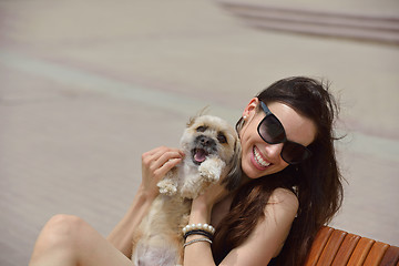 Image showing happy young woman with puppy have fun