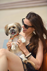 Image showing happy young woman with puppy have fun