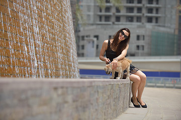 Image showing happy young woman with puppy have fun