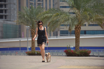 Image showing happy young woman with puppy have fun