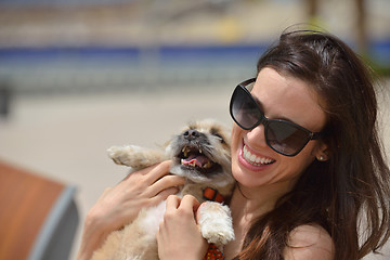 Image showing happy young woman with puppy have fun