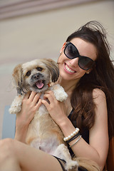 Image showing happy young woman with puppy have fun