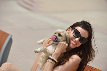 Image showing happy young woman with puppy have fun