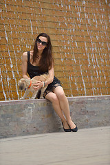 Image showing happy young woman with puppy have fun