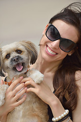 Image showing happy young woman with puppy have fun