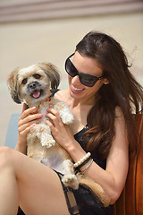 Image showing happy young woman with puppy have fun