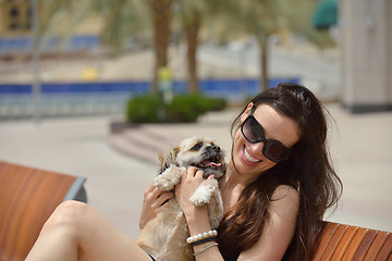 Image showing happy young woman with puppy have fun