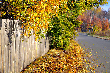 Image showing Golden autumn, old fence and road...