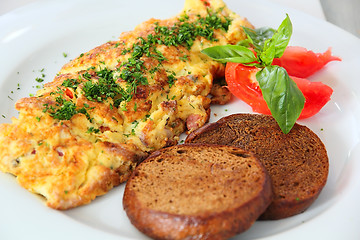 Image showing Omelette with toast at the table