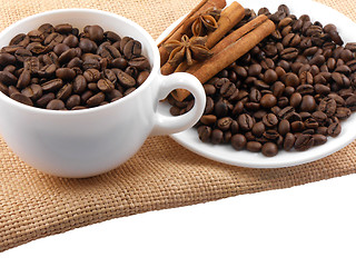 Image showing Cup with coffee beans and cinnamon