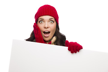 Image showing Shocked Girl Wearing Winter Hat and Gloves Holds Blank Sign 