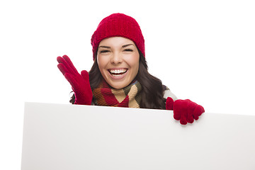 Image showing Thrilled Girl Wearing Winter Hat and Gloves Holds Blank Sign 