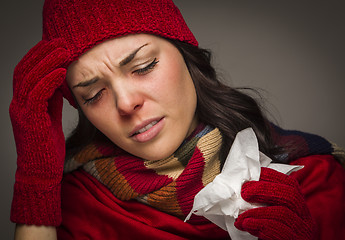Image showing Miserable Mixed Race Woman Blowing Her Sore Nose with Tissue