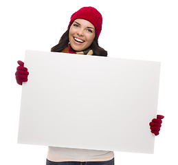 Image showing Excited Girl Wearing Winter Hat and Gloves Holds Blank Sign 