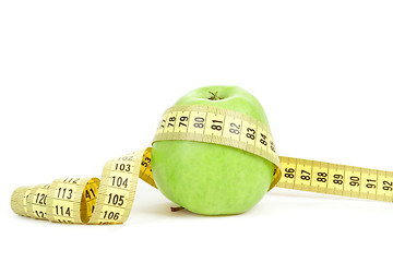 Image showing Green apple and measuring tape isolated on white background