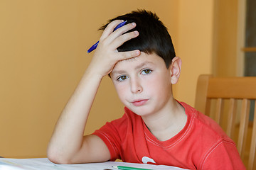 Image showing tired and bored boy doing school homework