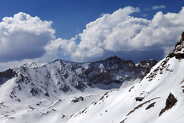 Image showing Snowy mountains and blue sky with cloud in sunny spring day