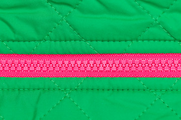 Image showing pink zipper on the green fabric