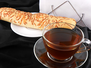 Image showing Hot tea with bread on black background