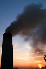 Image showing smokestack over sunset and blue sky