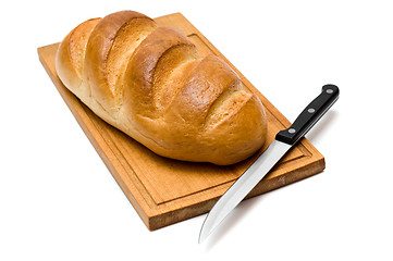 Image showing fresh natural bread with knife on breadboard