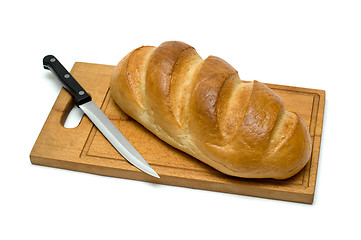 Image showing fresh natural bread with knife on breadboard