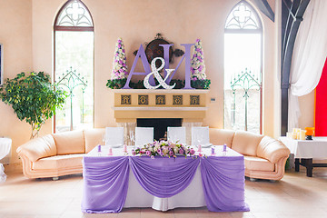 Image showing Bride and groom's table decorated with flowers