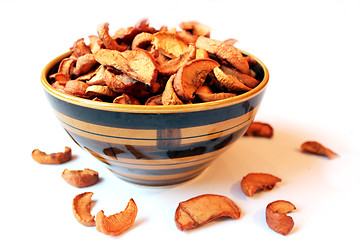 Image showing dried apples in the plate on the white background