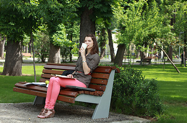 Image showing Woman Drinking Coffee in a Park