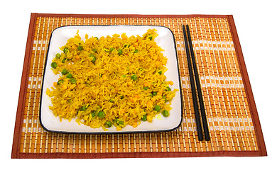 Image showing Rice with vegetables and chopsticks on bamboo mat