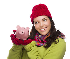 Image showing Mixed Race Woman Wearing Winter Hat Holding Piggybank on White 