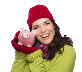 Image showing Happy Mixed Race Woman Wearing Winter Hat Holding Piggybank