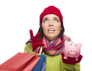 Image showing Stressed Mixed Race Woman Holding Shopping Bags and Piggybank