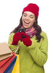 Image showing Mixed Race Woman Holding Shopping Bags Texting On Cell Phone 