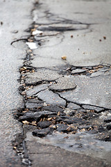 Image showing Broken pavement and pothole asphalt road after winter.