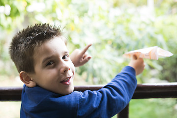 Image showing Kid throws paper plane