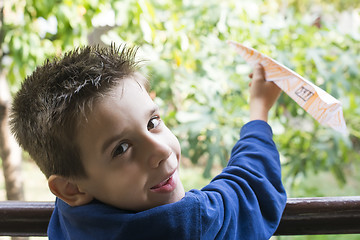 Image showing Kid throws paper plane