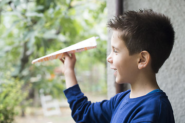 Image showing Kid throws paper plane