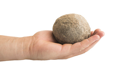 Image showing Hand holding stone ball