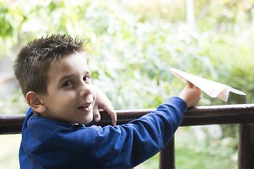 Image showing Kid throws paper plane