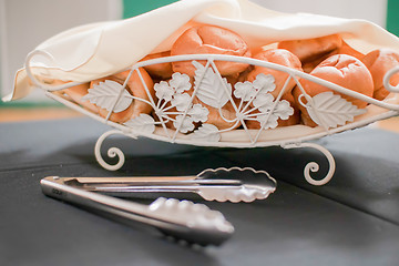 Image showing Tasty rolls lying on a white napkin in a basket