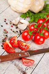 Image showing fresh tomatoes, buns, spices and old knife 